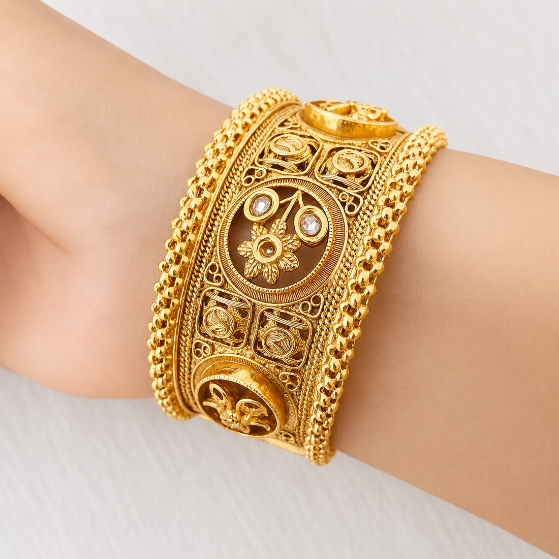 Intricate Gold Cuff with Gemstones